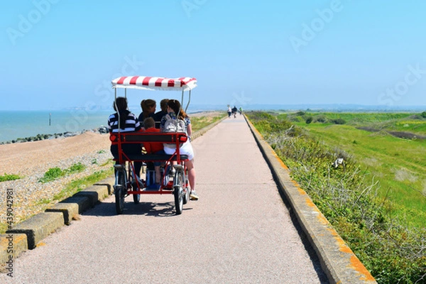 Obraz Adult pedal couple bike that locals and tourists ride along the Viking coastal path from Birchington-on-Sea to Reculver and Herne Bay The four wheel bikes can been hired from 15 British pounds an hour
