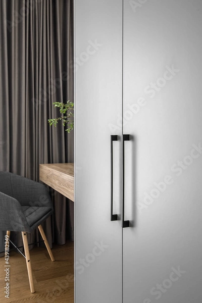 Fototapeta Elegant mirror on wooden frame wall above minimal wood console table in trendy bedroom interior of grey tones