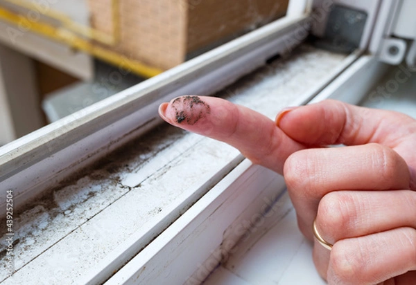 Fototapeta A dirty finger with dirt showing the need for cleaning the house, washing PVC window frames. Cleaning concept.