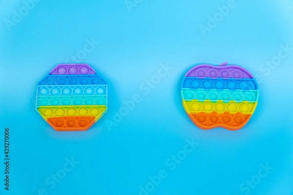 Obraz colorful silicon antistress sensory toy fidget push pop it on blue background