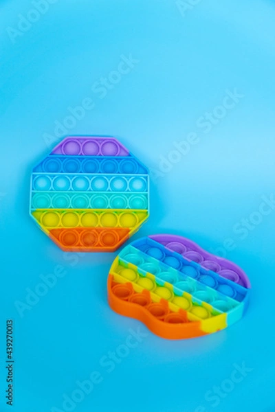 Obraz colorful silicon antistress sensory toy fidget push pop it on blue background