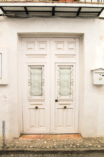 Fototapeta Whitewashed facade with beautiful white wooden door