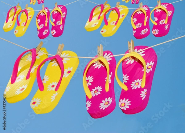 Fototapeta Multiple Pairs of Flipflops on clothes lines