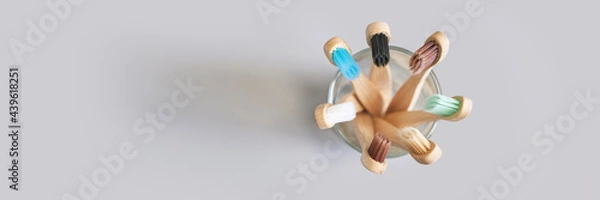 Fototapeta Set of ecology toothbrush on grey background. Different color at glass. Diversity concept. Sustainable mouth product. Zero waste lifestyle. Organic accessory group. Biodegradable recycle