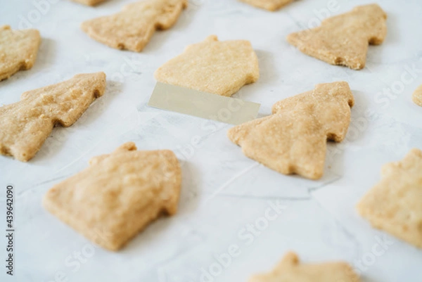 Fototapeta Flat lay of gingerbread with shape of christmas tree and houses