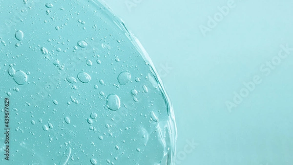 Fototapeta Background from cosmetic gel with bubbles,dripping down.Pastel blue color,copy space for text or design.Top view,antibacterial liquid surface.Good as background or mockup.Large banner.