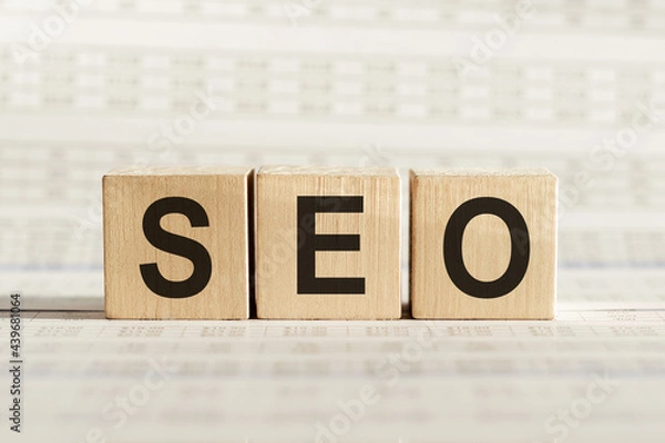 Obraz SEO abbreviation - search engine optimization, on wooden cubes on a light background.