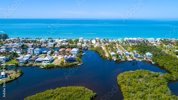 Fototapeta Aerial drone photo in Florida with the beach in the background and bay waters with mangroves in the foreground