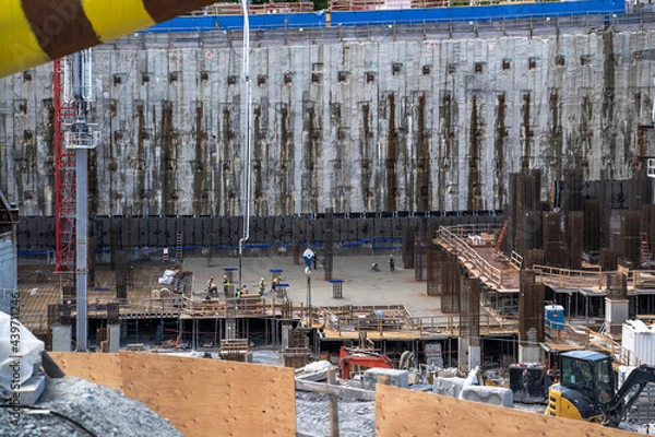 Fototapeta Wide Angle View Of Concrete Pouring In Construction Pit