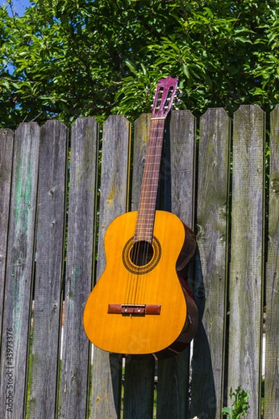 Fototapeta Guitar and the old wagon wheel