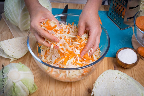 Fototapeta Step-by-step process of harvesting sauerkraut. Autumn pickling of cabbage. The concept of food from fermented canned vegetables.