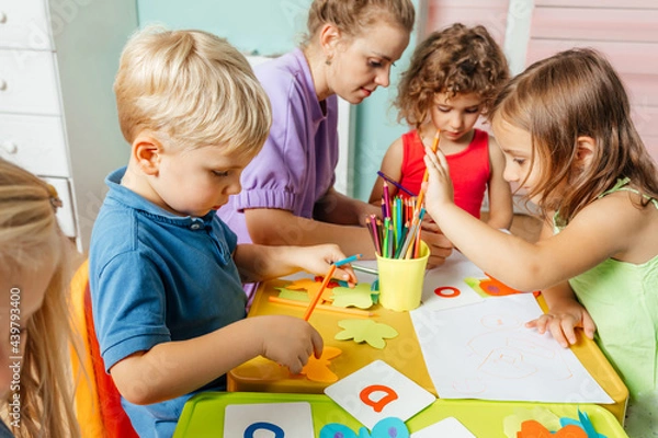 Obraz Preschool children learn english alphabet using cards