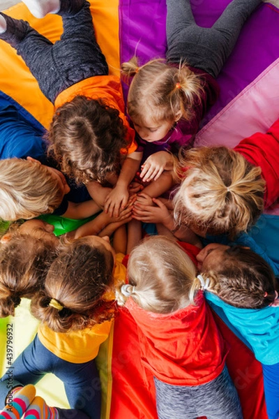 Obraz Cheerful children playing team building games on a floor