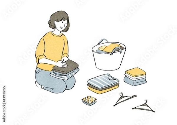 Fototapeta 洗濯物をたたむ女性