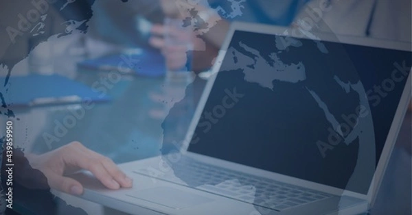 Obraz Globe against mid section of man using laptop at office