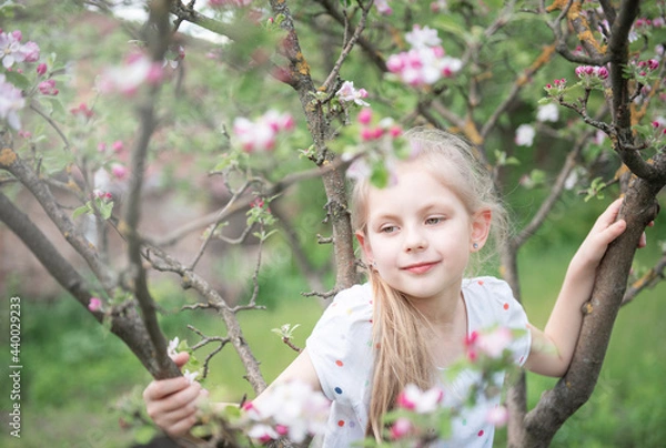 Obraz Little adorable girl in blossoming garden