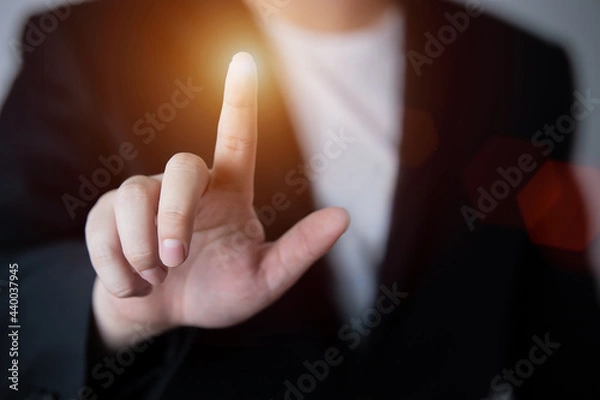 Fototapeta Businessman pushing a button on a touch screen interface , Finger pointing in the empty space. with business and advertising copy space.