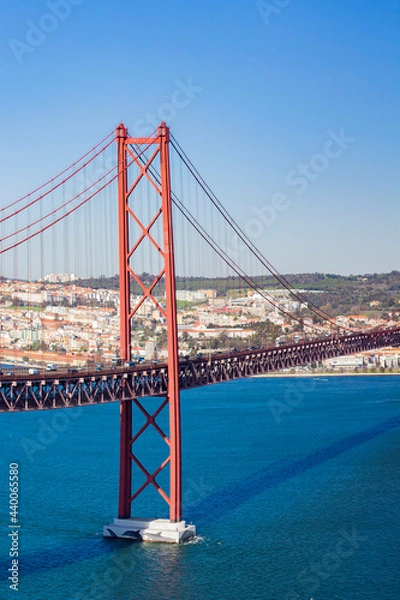 Fototapeta View from Almada of suspension  Ponte 25 de Abril bridge (The 25th April Bridge) over river Tejo, Tegaus in Lisbon, Portugal. Bridge alike Golden gate in Portugal. 