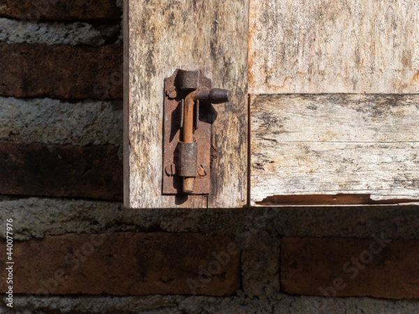 Fototapeta brown wooden door opens with latch lock. very classic and attractive.