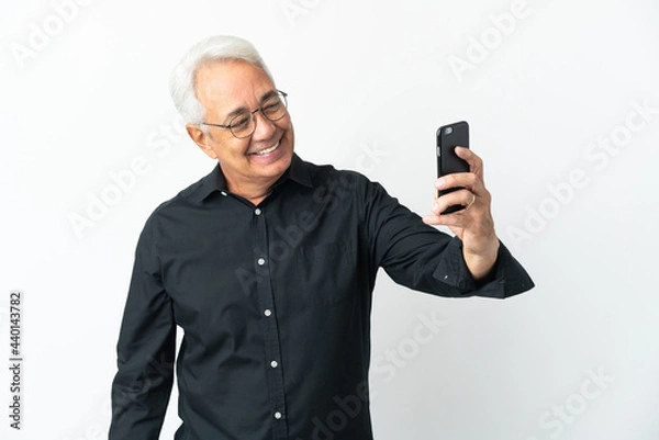 Fototapeta Middle age Brazilian man isolated on white background making a selfie