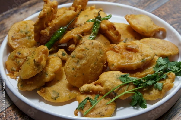 Obraz Vegan Aloo Pakora, Aloo Pakoda, Potato Fritters a thin slice of Potato dipped in Gram flour with spices and deep fried.