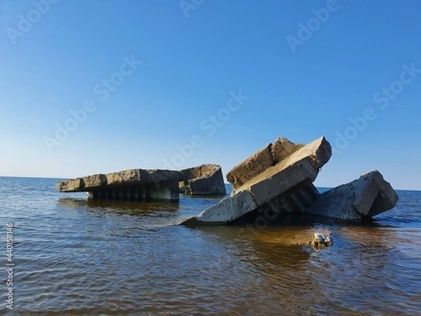 Fototapeta Ruins of an old building.  The building was built in the water, now there is not much left of it.
