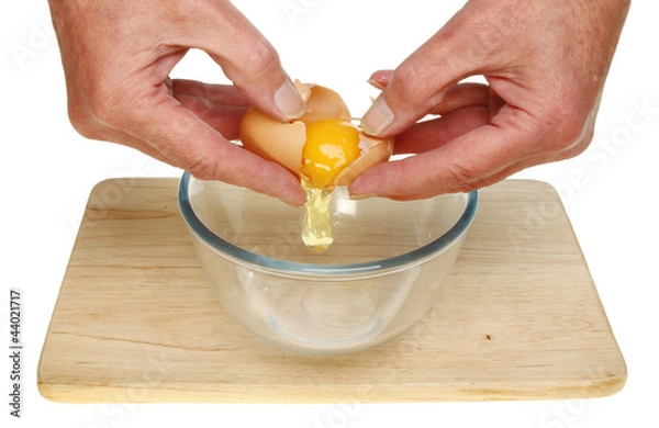 Fototapeta Hands cracking egg