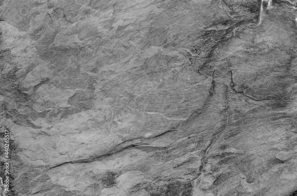 Fototapeta Black and white background. Gray rock texture. Grunge stone background. The texture of the mountains. Close-up. Grunge banner with volumetric rock texture