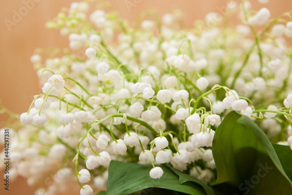 Fototapeta Bouquet of white lily of the valley flowers on wooden background with copy space, beautiful card	