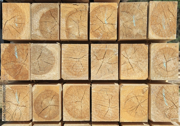 Fototapeta pine timber is stacked in rows. timber for building a house. ends of a rectangular bar.