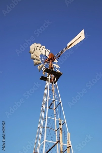 Obraz rusty old water pumping windmill