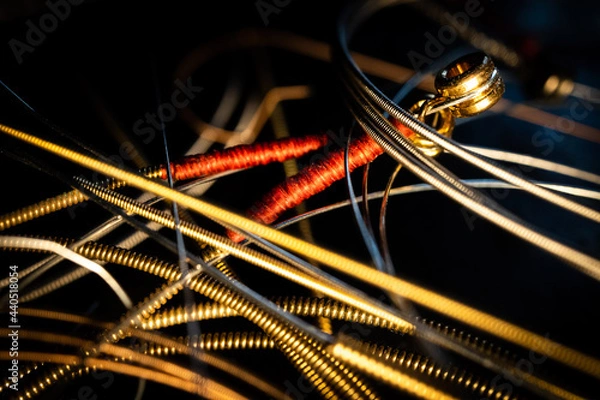 Fototapeta Macro Closeup of Ball End and Wrapping on End of Bronze Guitar Strings in Loose Group of Strings