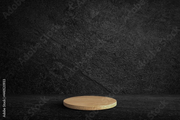 Fototapeta Round wooden product stand on black wall texture rough background dark stone wall or grunge background with black.