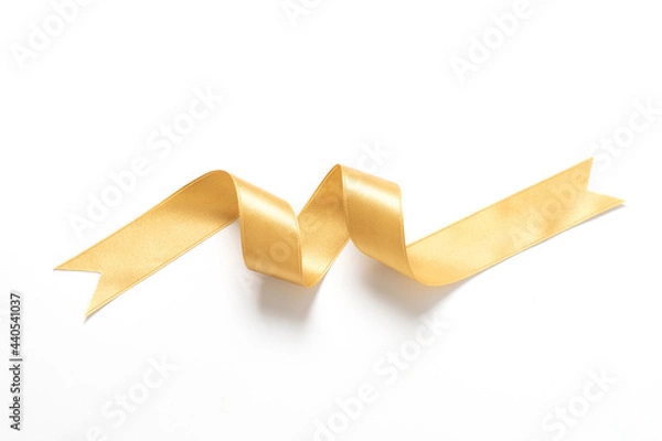 Fototapeta A roll gold color ribbon isolated on white