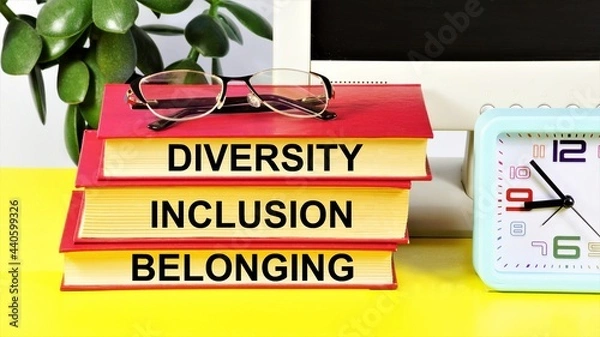 Fototapeta Diversity Inclusion Belonging. Text inscription on books. Business imperative, cultural value.