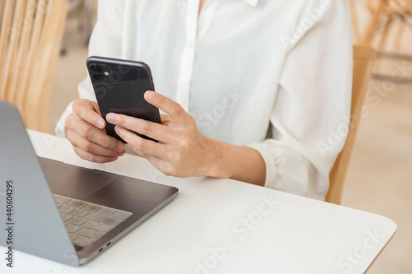 Fototapeta using texting cell phone typing computer.student study education online learning.adult professional chatting on laptop,mobile contact us at Thinking business plan.connecting people concept