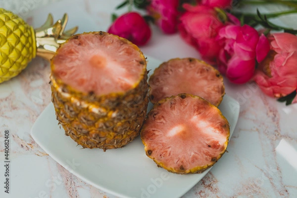 Obraz sliced pink pineapple on a plate with peonies