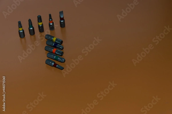 Obraz multi-colored bits from a screwdriver, tools for assembly, free space for insertion, selective focus