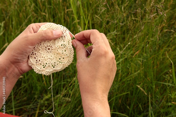 Obraz Woman's hands crocheting doily with hook, handmade process closeup