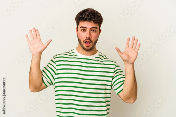 Fototapeta Young caucasian man isolated on white background screaming to the sky, looking up, frustrated.
