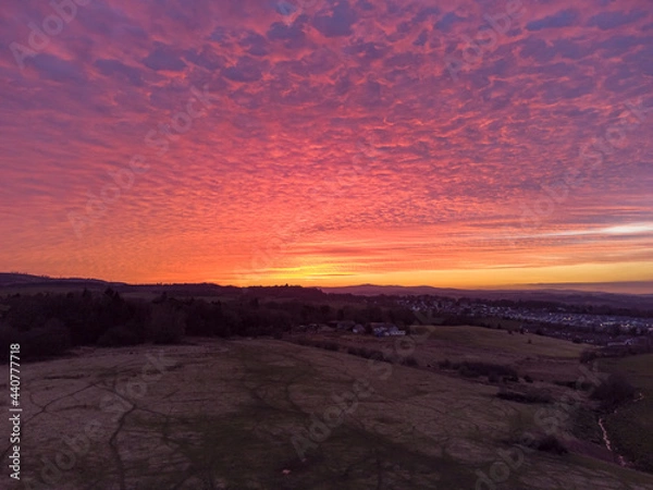 Fototapeta Sunset over fields and farmland
