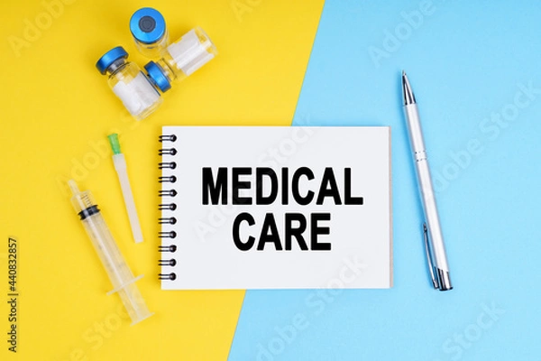 Fototapeta A syringe, ampoules and a notebook with the inscription - MEDICAL CARE