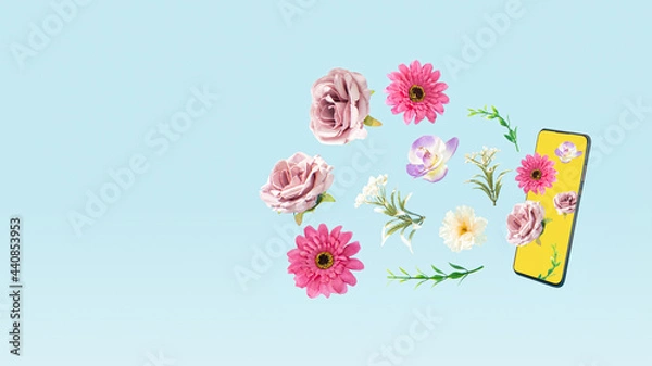 Obraz Creative concept of fresh Spring flowers coming out of a cell phone. A call that anyone would respond to. Pastel blue background.