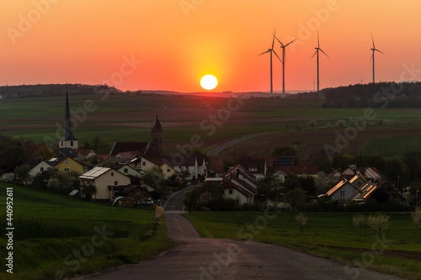 Fototapeta sunset over the village