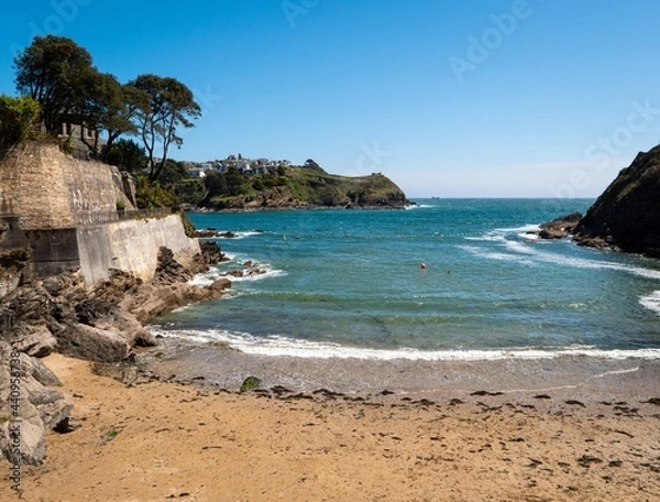 Fototapeta Looking out to sea from the sandy beach of Readymoney Cove at Fowey, on the south coast of Cornwall, UK.