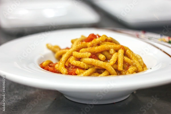 Fototapeta Passatelli, fresh pasta made with Parmigiano Cheese, bread crumbs and clove