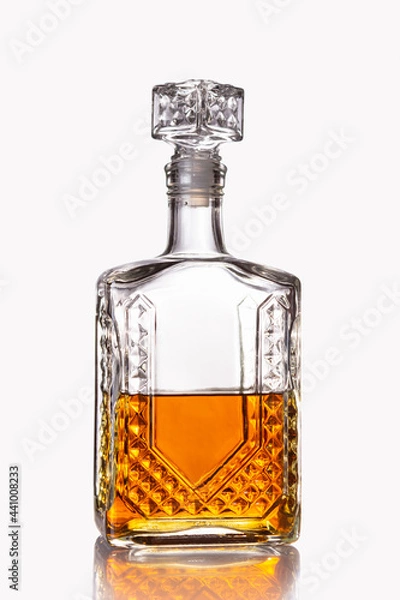 Obraz Glass decanter half filled with cognac or other alcoholic beverage isolated on a white background.