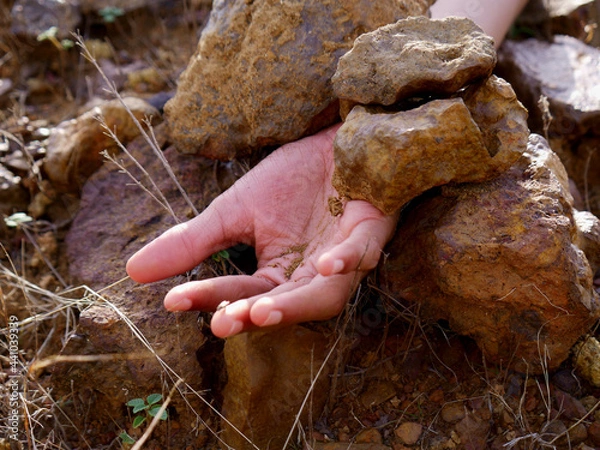 Obraz Boy hand presented down the stone rocks, land slide concept.