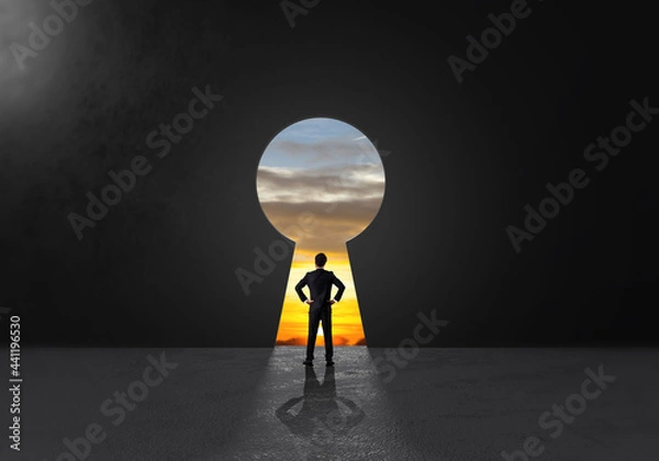 Fototapeta Success businessman stand and looking key success hole for think of strategy