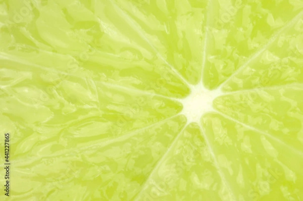 Fototapeta Green background juicy lime close up